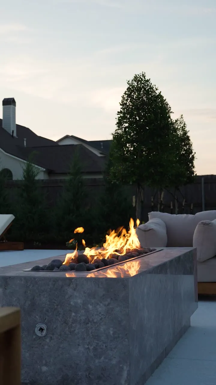 Fire bowl beside a pool at dusk