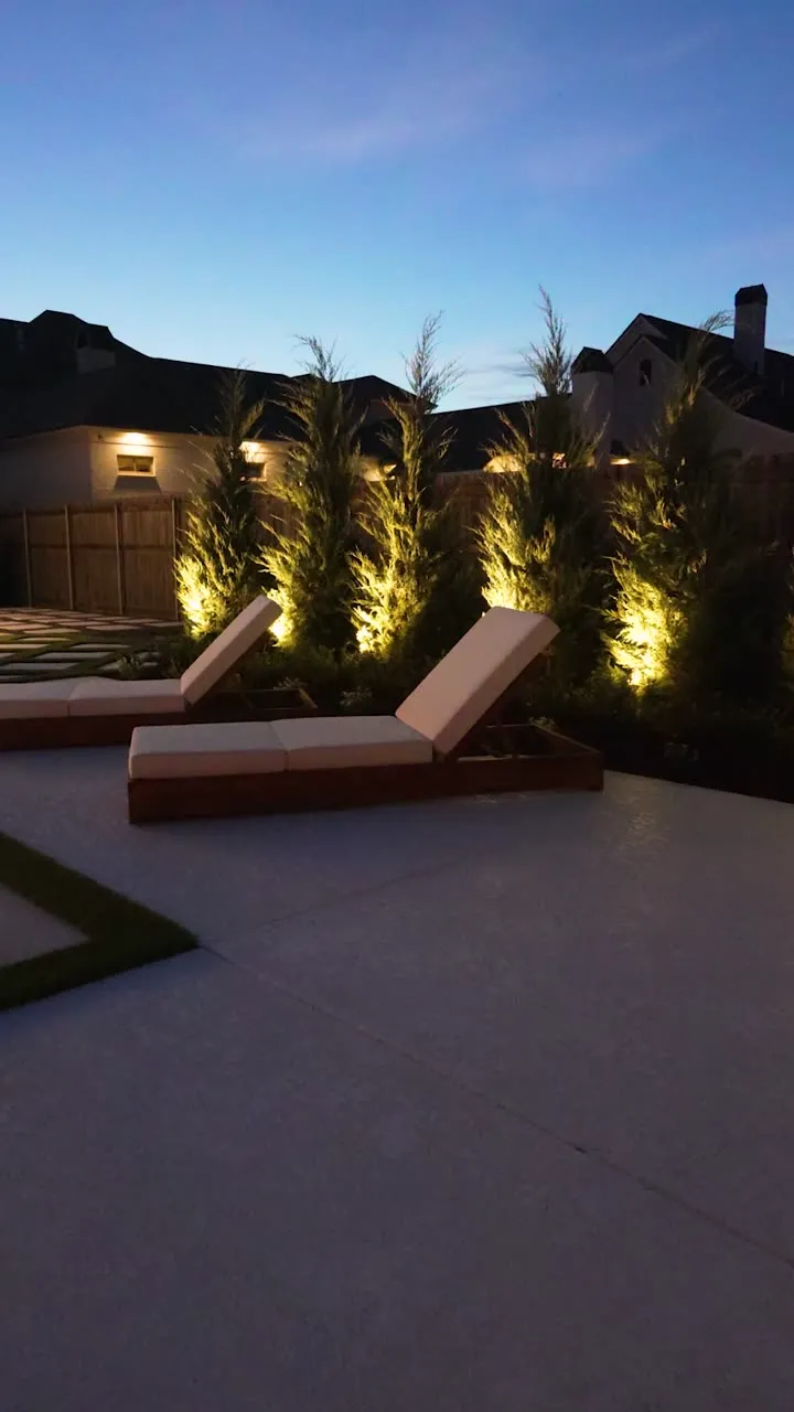 Pool deck with loungers and landscape lighting